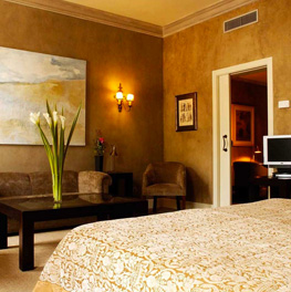 Cozy bedroom with warm lighting and elegant decor.